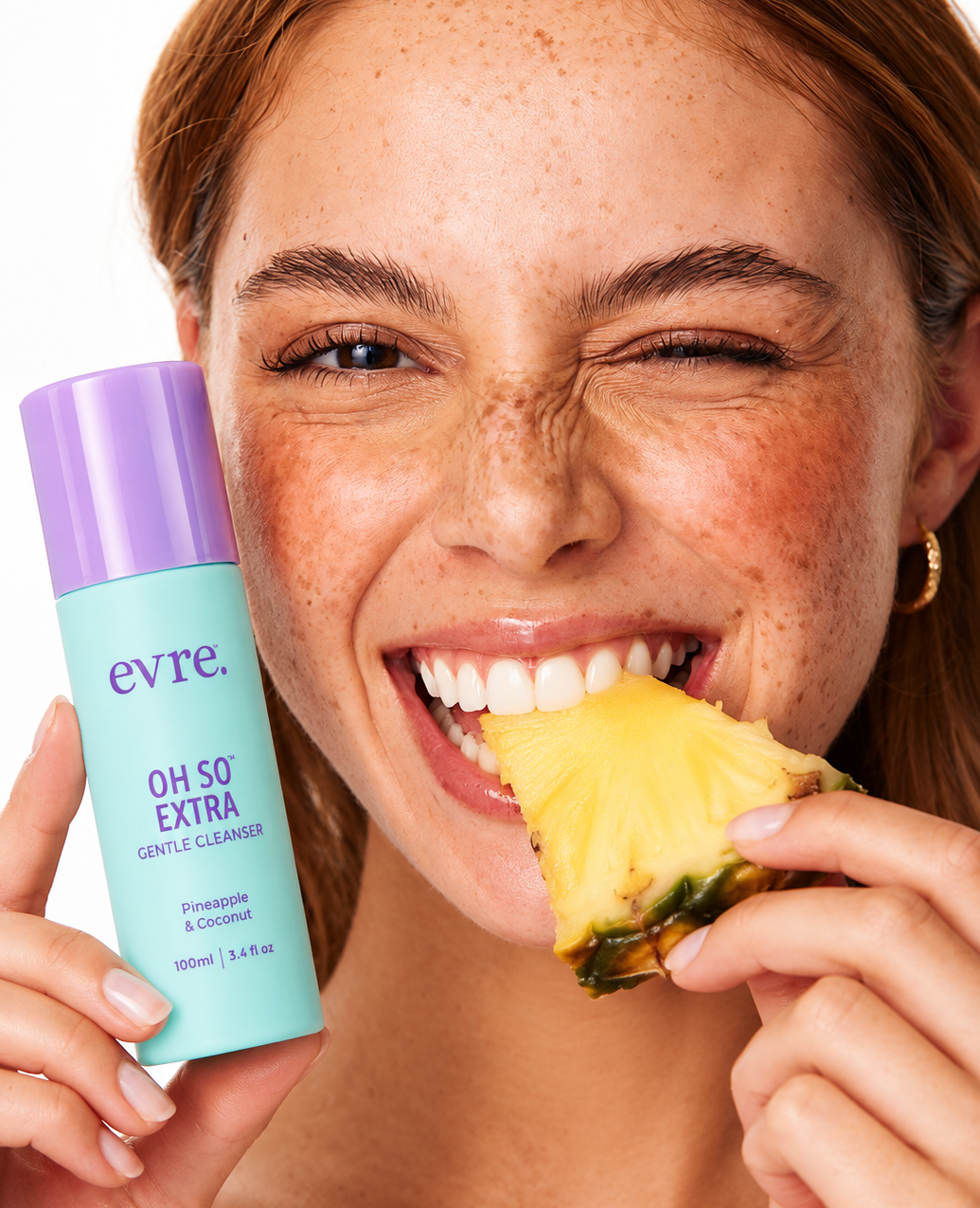 Smiling woman holding evre. skincare and a pineapple slice
